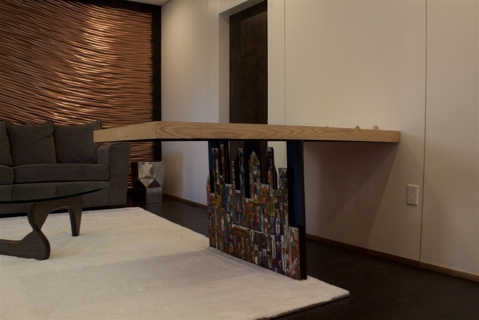 Copper-toned CNC-carved wave accent wall behind a sofa