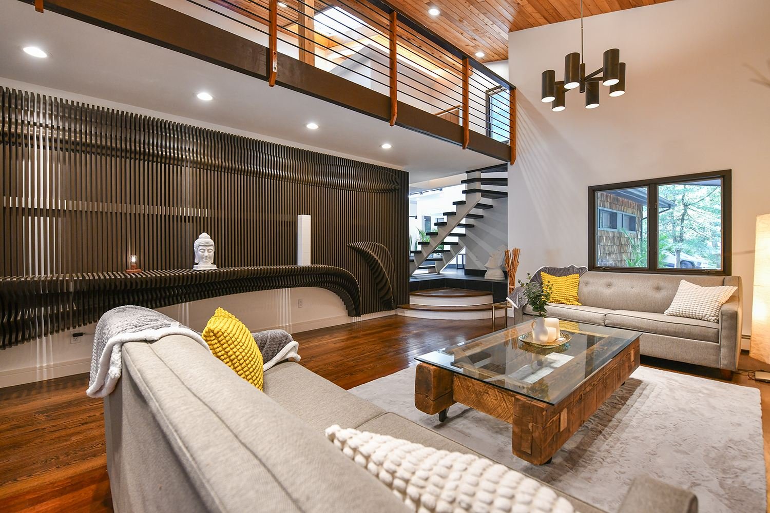 Two-story parametric slat wave wall flowing across a modern living room